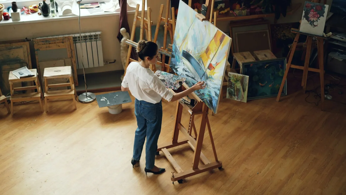 Artists demonstrating painting techniques during a masterclass