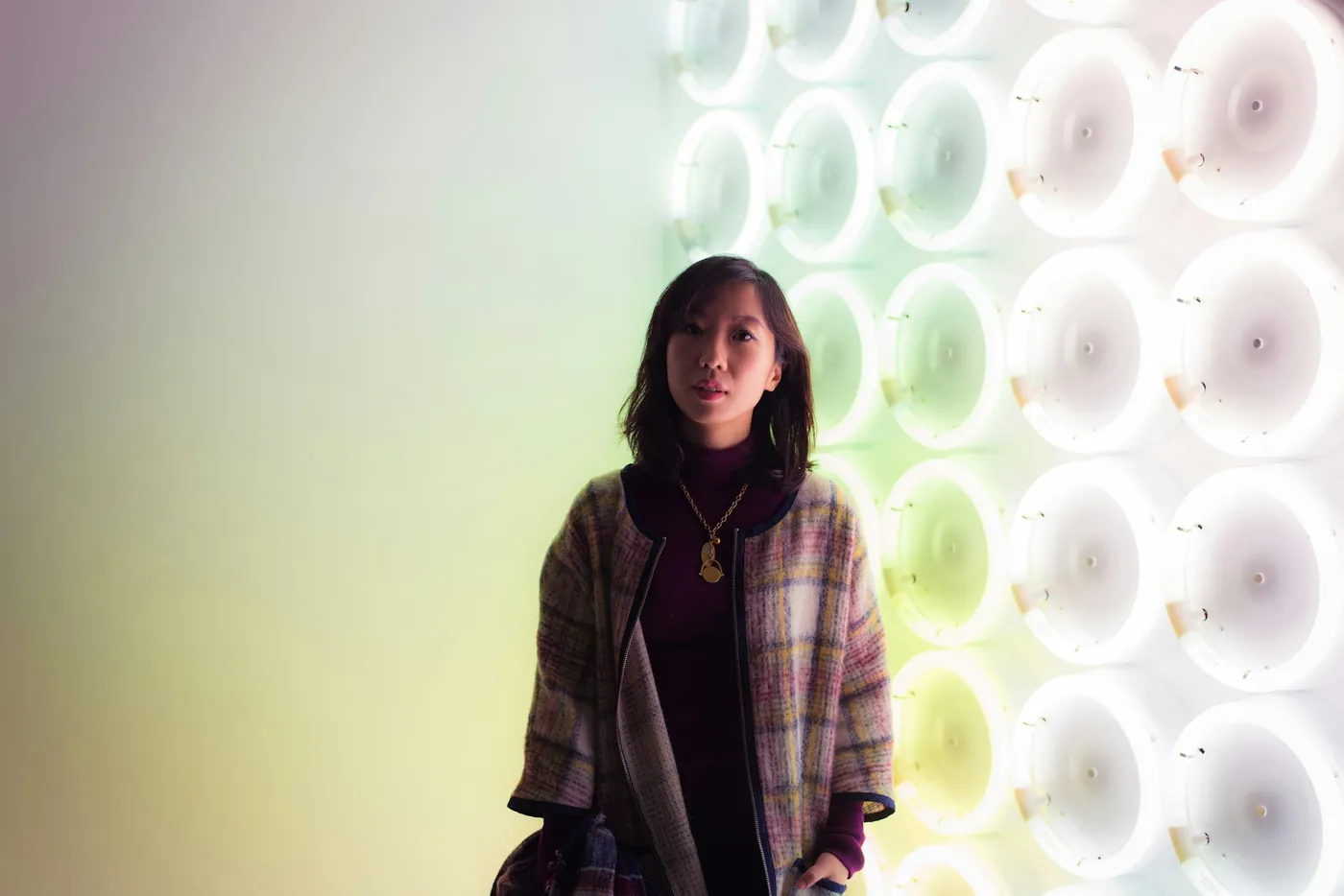 Woman in a white and grey plaid blazer