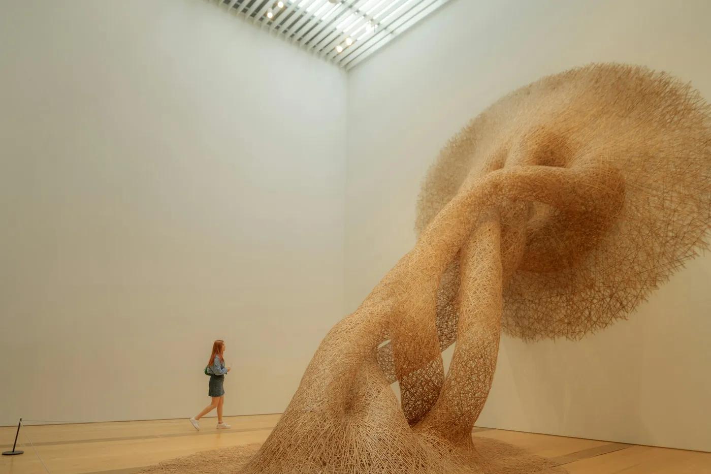 A woman looks at a large abstract art installation